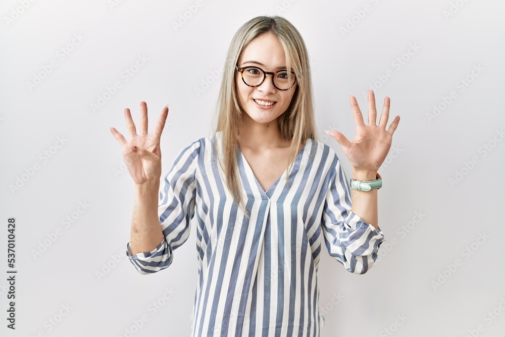 Asian young woman wearing casual clothes and glasses showing and pointing up with fingers number nine while smiling confident and happy.