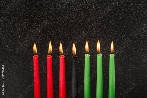 Kwanzaa festival concept with seven candles red, black and green on black background, copy space