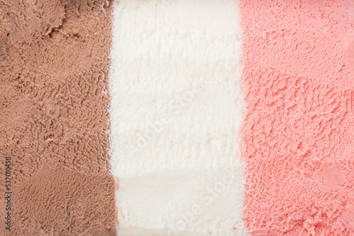 texture of pink, white and chocolate ice cream like background, close up