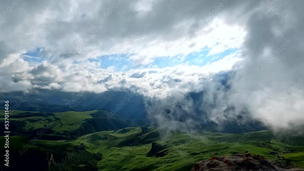 Timelapse of beautiful tropical valley between mountains with moving white clouds in sky Timelapse of beautiful tropical valley between mountains with moving white clouds in sky