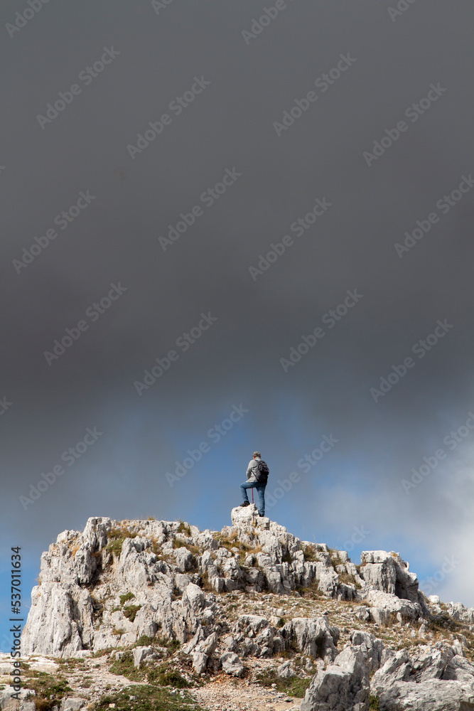 Hiker on the summit of a mountain Hiker on the summit of a mountain