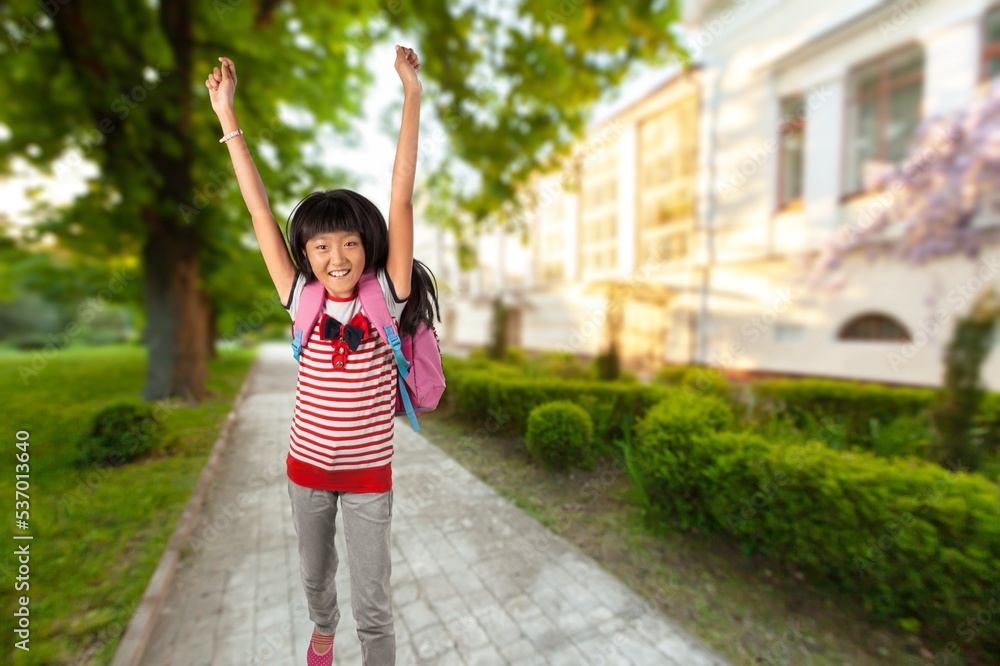 Happy small school child running on street. Happy small school child running on street.