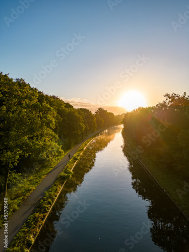 Beautiful sunset over a river with green bushes and color rich sky. High quality photo