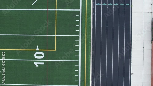 4K aerial of an American turf football field moving toward the ground photo