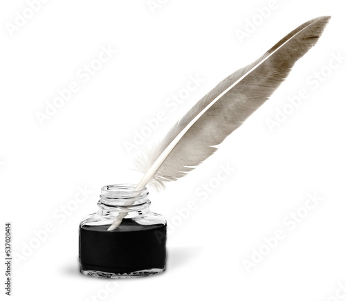 Feather quill pen and glass inkwell isolated on a white background photo