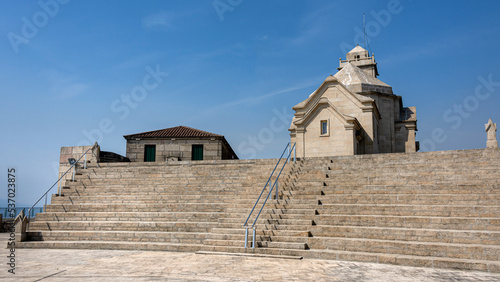 Portugal  near Mondim de Basto and Vilar de Ferreiros  Famous church Santuario de Nossa Senhora da Graca on Portuguese Monte Farinha with steeple  bells  stairs  blue sky - concept religion tourism