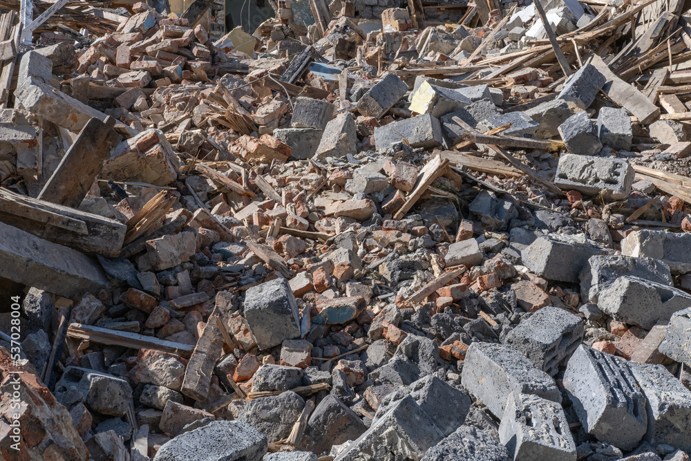 Garbage after the demolition of the building. Broken walls, windows. The process of demolishing an old building. Demolition of dilapidated housing for new development