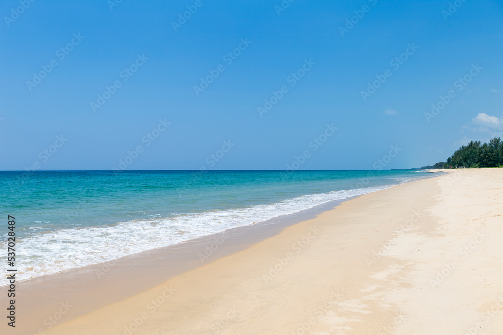 Tropical beach background, clean sandy beach with blue sea background, summer outdoor day light