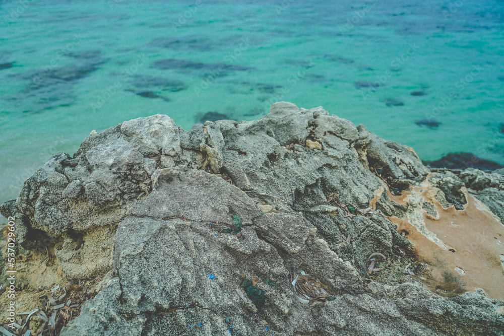 Clear sea behind a group of rocks on the Italian coast