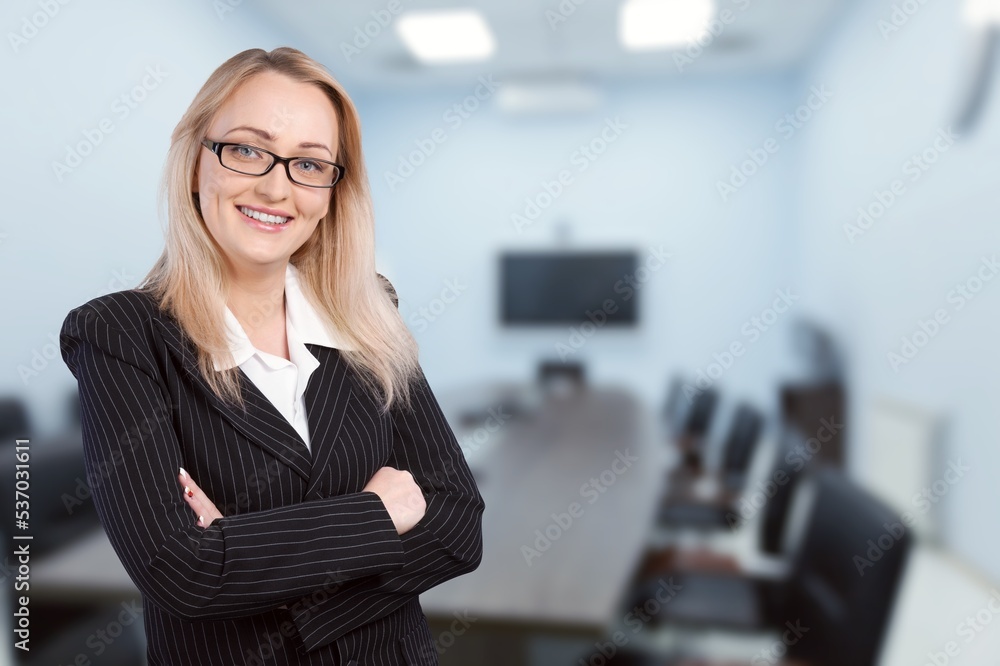 Successful business female stands in modern office Successful business female stands in modern office