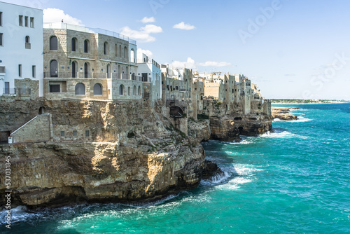 Spectacular houses of the old town of Polignano a Mare built on the cliffs above the Adriatic Sea view from the sea on a beautiful sunny day