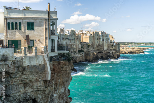 Spectacular houses of the old town of Polignano a Mare built on the cliffs above the Adriatic Sea view from the sea on a beautiful sunny day photo