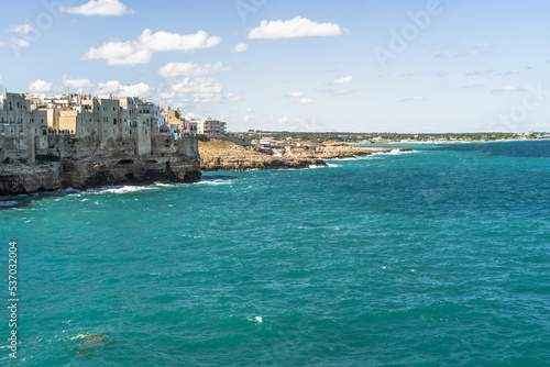 Fototapeta Naklejka Na Ścianę i Meble -  Spectacular houses of the old town of Polignano a Mare built on the cliffs above the Adriatic Sea view from the sea on a beautiful sunny day