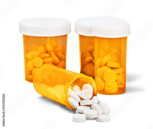 Medication pills in pills bottles on background photo