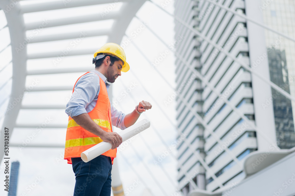Man engineer standing on construction site. Engineer working on outdoor project Man engineer standing on construction site. Engineer working on outdoor project