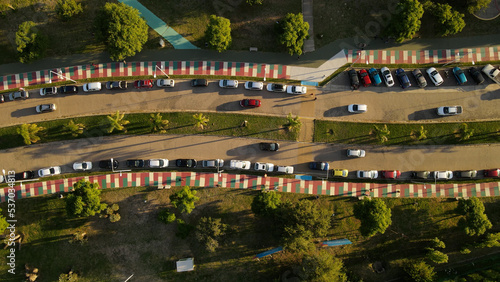 Aerial flyover scenic road with colored asphalt and driving cars in suburb area of Cordoba,Argentina