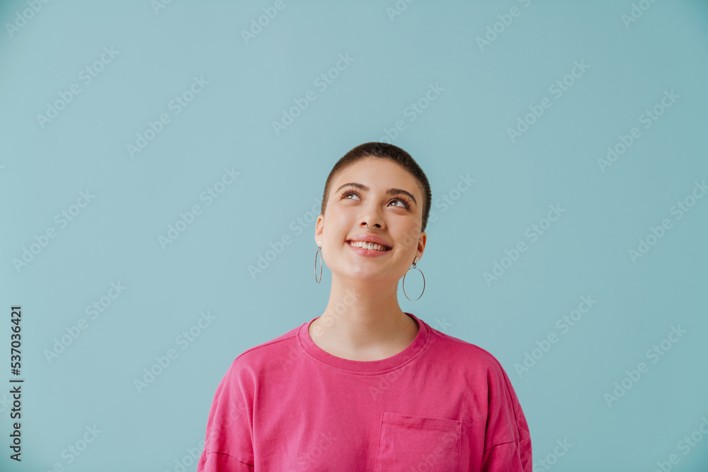 Young woman with short haircut smiling and looking upward Young woman with short haircut smiling and looking upward