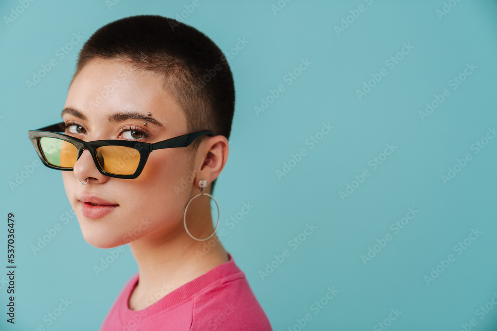 Young woman wearing sunglasses posing and looking at camera Young woman wearing sunglasses posing and looking at camera