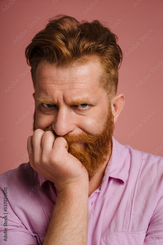 Ginger sad man with beard frowning and looking at camera Ginger sad man with beard frowning and looking at camera