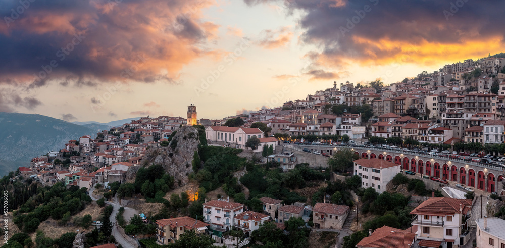 Arachova Greece mountain town aerial drone view. Traditional houses at sunset