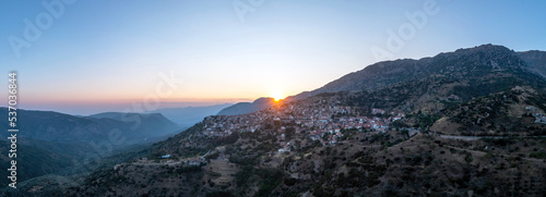 Arachova Greece mountain town aerial panorama. Traditional houses at sunset