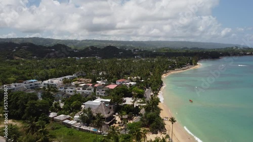 Aerial drone video of tropical paradise beach with blue waters, white sand and palm trees in Samana, Dominican Republic, Caribbean.