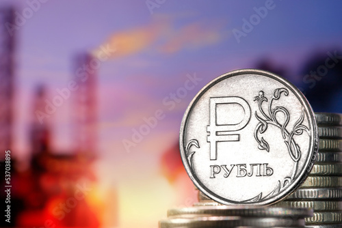 Natural propane gas flame and ruble currency. Gas burner and ruble coin, Russian money on home gas stove.  Concept of Russia and Europe economy photo