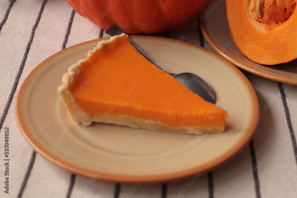 Plate with piece of fresh homemade pumpkin pie on table Plate with piece of fresh homemade pumpkin pie on table