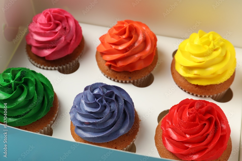 Many delicious colorful cupcakes in box, closeup Many delicious colorful cupcakes in box, closeup