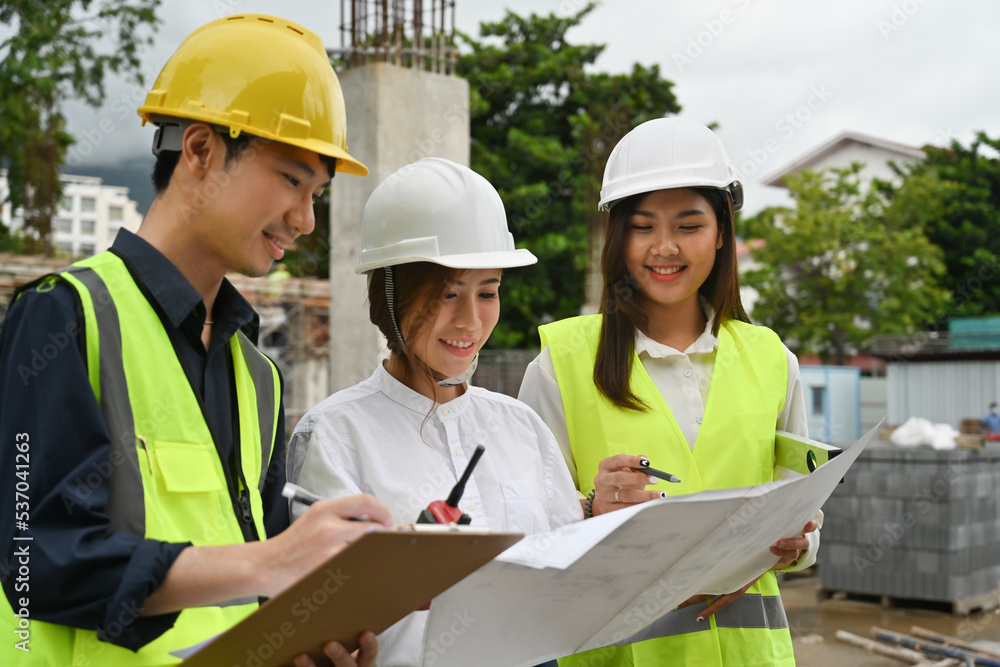 Portrait with Chief engineer and foreman team checking residential project development at construction site. Group of successful construction workers enjoy working, and bonding with teamwork. Portrait with Chief engineer and foreman team checking residential project development at construction site. Group of successful construction workers enjoy working, and bonding with teamwork.