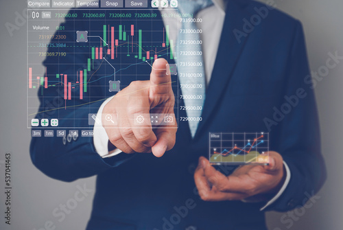 Businessman analysing trading graph financial data. Business finance background.Business finance technology and investment concept.business finance technology and investment concept.