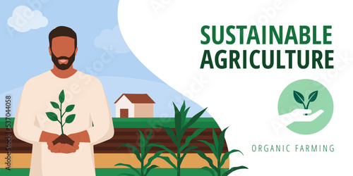 Smiling farmer holding soil and a sprouting plant