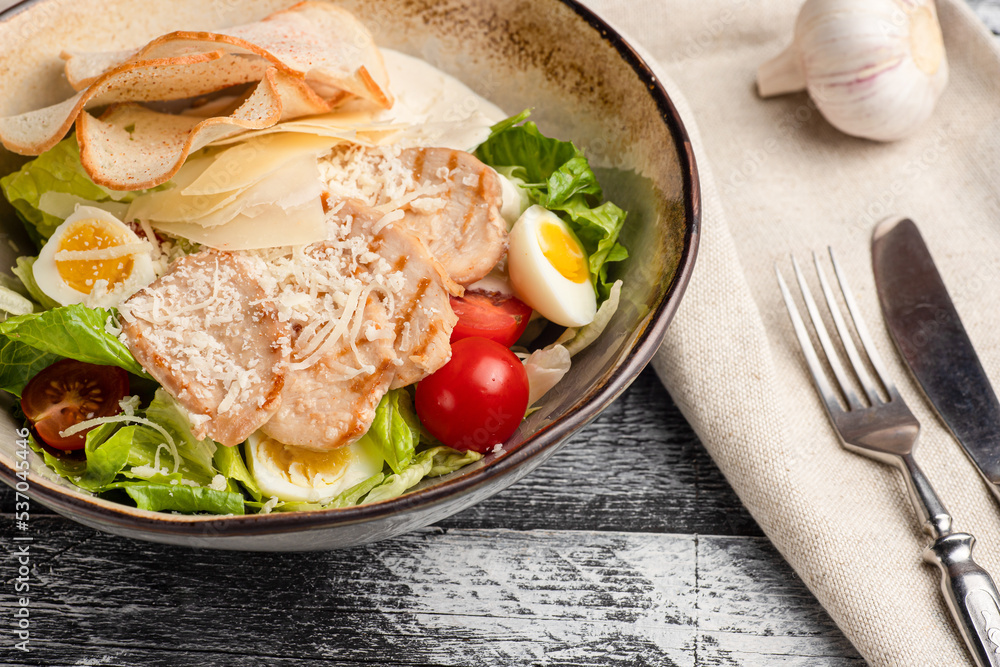 Caesar salad, caesar with chicken salad on a white background, side view Caesar salad, caesar with chicken salad on a white background, side view