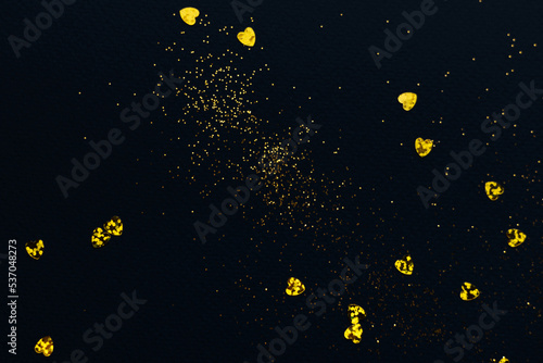 Dark blue background with golden glitter and hearts confetti