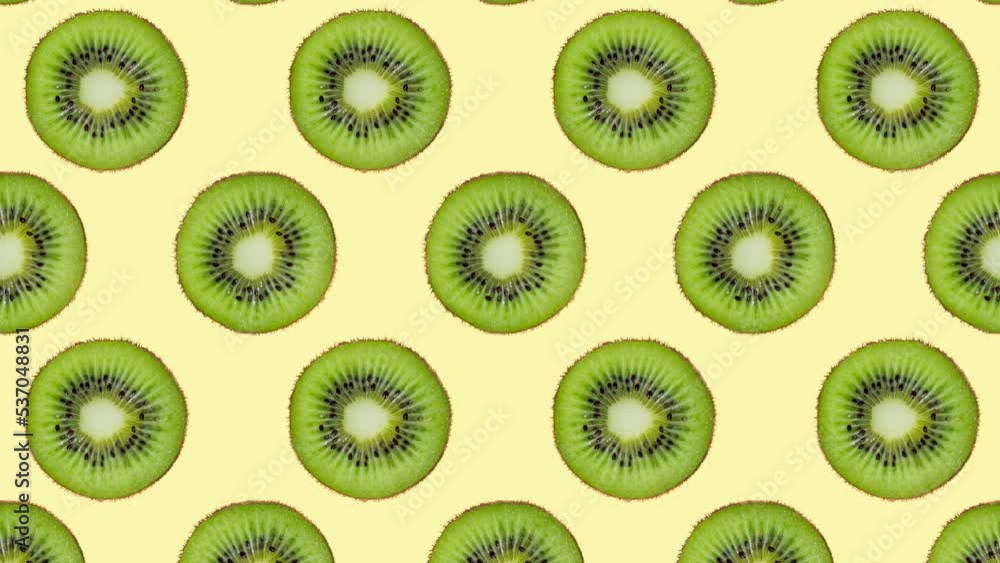 Minimal motion design - Kiwi slices rotating and moving down at yellow color background. Trendy colors and style graphics. Seamless looping animation. Minimal motion design - Kiwi slices rotating and moving down at yellow color background. Trendy colors and style graphics. Seamless looping animation.