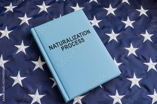 USA flag and a book about the naturalization process.