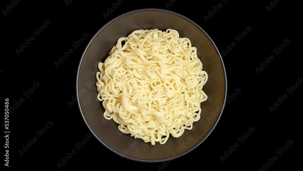 Instant noodles in grey bowl isolated on black background, rotating, turning, close-up macro, top view.
Instant noodles in grey bowl isolated on black background, rotating, turning, close-up macro, top view.