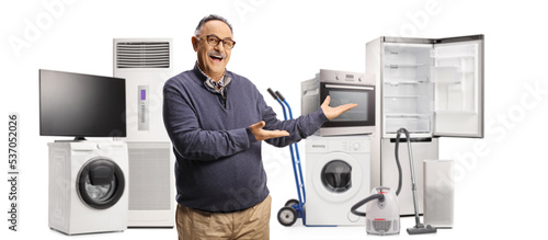 Cheerful mature man showing a group of electrical home appliances