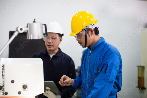 experienced operator technician worker or engineer metalworker industrial in safety helmet working or repair on metal machine, professional maintenance skill man in industry manufacturing. men at work