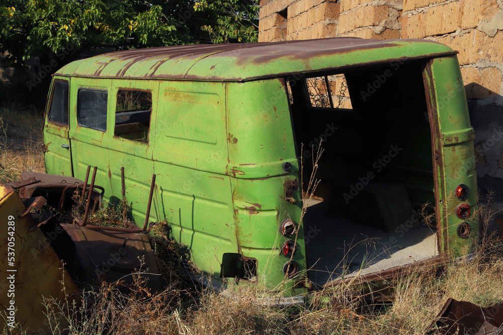 Body of an abandoned rusty minibus of unknown brand