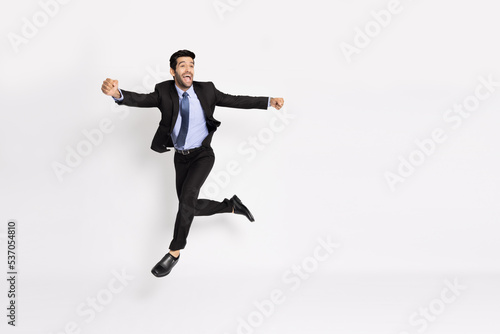 Young businessman jumping in air isolated on white background, Full length composition