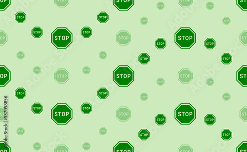 Seamless pattern of large and small green stop road signs. The elements are arranged in a wavy. Vector illustration on light green background