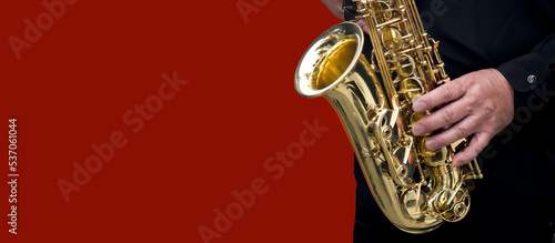 close-up of the hands of a musician playing the saxophone photo