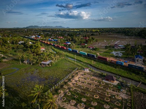 Kampot, Cambodia - 26 May 2022: Aerial view of a train across the countryside, Kampot province, Cambodia. photo