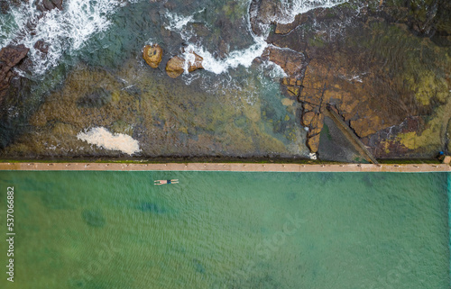 Aerial view of a person swimming in North Narrabeen Rockpool, New South Wales, Australia. photo