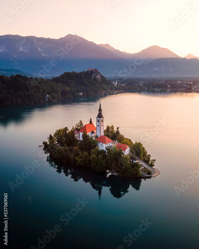 Aerial view of Cerkev Marijinega, a Catholic Church on a small island in the middle of Bled Lake at sunrise, Upper Carniola, Julian Alps, Slovenia. photo