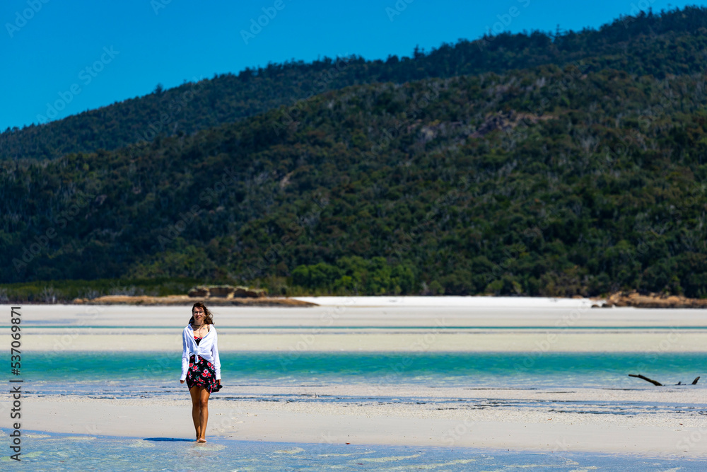 a beautiful girl in a dress, shirt and hat enjoys a walk on the white dunes at whitehaven beach; paradise beach with white sand and turquoise waters; whistundays island holiday, queensland, australia; a beautiful girl in a dress, shirt and hat enjoys a walk on the white dunes at whitehaven beach; paradise beach with white sand and turquoise waters; whistundays island holiday, queensland, australia;