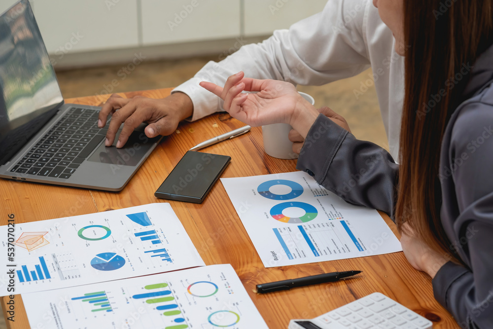 Business men and women sat happily looking at the company's annual profitable paperwork and paperwork. Business men and women sat happily looking at the company's annual profitable paperwork and paperwork.