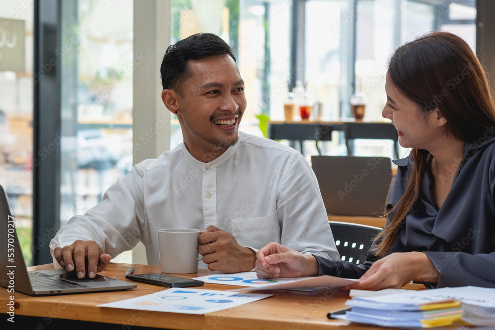 Business men and women sitting looking at each other with coffee cups and talking in the company. Business men and women sitting looking at each other with coffee cups and talking in the company.
