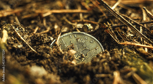 Φωτογραφία An old silver coin in the ground